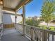Inviting covered front porch offering a relaxing outdoor space with neighborhood views at 12734 E 104Th Pl, Commerce City, CO 80022
