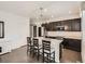 The kitchen features a large island with bar stool seating, stainless appliances and wood floors at 12734 E 104Th Pl, Commerce City, CO 80022