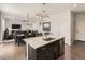 Open kitchen with a large island and bar stool seating that connects to the dining and living areas at 12734 E 104Th Pl, Commerce City, CO 80022