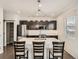 This kitchen features a large island with bar stool seating and stylish pendant lighting at 12734 E 104Th Pl, Commerce City, CO 80022