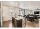Open kitchen with a large island, bar stool seating, pendant lighting and stainless steel dishwasher at 12734 E 104Th Pl, Commerce City, CO 80022