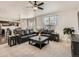 Open concept living room featuring plush carpeting, a ceiling fan and access to the kitchen and dining areas at 12734 E 104Th Pl, Commerce City, CO 80022