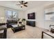 Inviting living room features a ceiling fan, large window, stylish furniture, and a modern entertainment center at 12734 E 104Th Pl, Commerce City, CO 80022