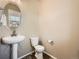 Bright powder room featuring a pedestal sink, modern fixtures, oval mirror, and neutral wall color at 12734 E 104Th Pl, Commerce City, CO 80022