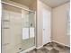 Clean shower with glass doors and chrome fixtures, tile surround, and handy grab bars at 12734 E 104Th Pl, Commerce City, CO 80022
