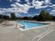 Community pool with lounge chairs and clear blue water, perfect for summer days at 12734 E 104Th Pl, Commerce City, CO 80022
