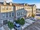 Three-story townhouses with attached garages and snow-covered landscaping at 909 Burning Bush Pt, Monument, CO 80132