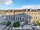 Three story townhouses with attached garages and snowy landscaping at 909 Burning Bush Pt, Monument, CO 80132