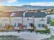 Aerial view of townhomes featuring private decks and snow-covered yards with a view of mountains at 909 Burning Bush Pt, Monument, CO 80132