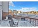 Back deck with grill and table overlooking a snow covered yard with a pond at 909 Burning Bush Pt, Monument, CO 80132