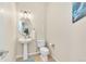 Half bathroom featuring a pedestal sink, toilet, and an oval mirror at 909 Burning Bush Pt, Monument, CO 80132