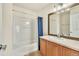 Clean bathroom featuring a shower-tub combo, tile floor, and wood vanity at 909 Burning Bush Pt, Monument, CO 80132