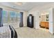 Bedroom with large windows, carpeted floors, a dresser, and access to the en-suite bathroom at 909 Burning Bush Pt, Monument, CO 80132