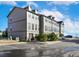 Exterior view of the townhome featuring neutral-colored siding and dark shutters on the windows at 909 Burning Bush Pt, Monument, CO 80132