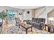 Bright living room featuring hardwood floors, comfortable seating, and natural light at 909 Burning Bush Pt, Monument, CO 80132