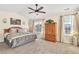 Spacious main bedroom featuring plush carpet, ceiling fan, and abundant natural light from the windows at 909 Burning Bush Pt, Monument, CO 80132