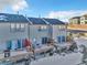 Townhome rear elevation shows private decks and sliding glass doors at 909 Burning Bush Pt, Monument, CO 80132