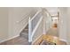 Carpeted staircase with white railing at 909 Burning Bush Pt, Monument, CO 80132