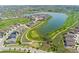 Stunning aerial view of neighborhood, golf course, pond, and the surrounding landscape at 15525 Quince Cir, Thornton, CO 80602