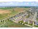 Wide aerial view of a well-planned neighborhood with manicured lawns and green spaces nearby at 15525 Quince Cir, Thornton, CO 80602