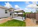 Backyard area with a gazebo, wooden fence, and grassy area with landscaped rock at 15525 Quince Cir, Thornton, CO 80602