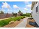 Landscaped backyard with a walking path, mature trees, and a wood fence at 15525 Quince Cir, Thornton, CO 80602