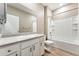 Bright bathroom with white cabinets, large mirror, and a shower over the tub at 15525 Quince Cir, Thornton, CO 80602