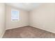 Serene bedroom with large window, neutral walls, and plush carpeting at 15525 Quince Cir, Thornton, CO 80602