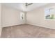 Unfurnished bedroom featuring neutral carpet, ceiling fan, and natural light at 15525 Quince Cir, Thornton, CO 80602
