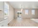 Bright dining area with modern light fixture, and sliders to the outdoor living area at 15525 Quince Cir, Thornton, CO 80602