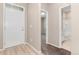 Bright entryway with hardwood floors, leading to the bathroom and carpeted rooms at 15525 Quince Cir, Thornton, CO 80602