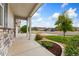 Covered front porch with stone accents providing a welcoming entrance to the home at 15525 Quince Cir, Thornton, CO 80602