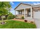 Close up of a well-maintained front yard with lush green grass and beautiful landscaping at 15525 Quince Cir, Thornton, CO 80602