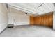 Empty two-car garage featuring a concrete floor and an automatic door opener at 15525 Quince Cir, Thornton, CO 80602