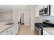 The kitchen is equipped with stainless steel appliances, granite countertops, and wood floors at 15525 Quince Cir, Thornton, CO 80602