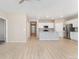 Open concept living room flows into kitchen with an island, and stainless steel appliances at 15525 Quince Cir, Thornton, CO 80602
