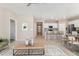 Staged living room flows into a kitchen with an island and barstools and modern decor at 15525 Quince Cir, Thornton, CO 80602