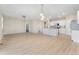 Open-concept space with kitchen island, stainless steel appliances, and hardwood floors at 15525 Quince Cir, Thornton, CO 80602