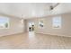 Bright and airy living room with hardwood floors, a ceiling fan, and sliding door for natural light at 15525 Quince Cir, Thornton, CO 80602