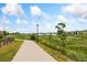 Scenic community walking path overlooking a beautiful lake and green spaces at 15525 Quince Cir, Thornton, CO 80602