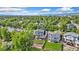 An aerial view of a well-maintained neighborhood with mature trees and green lawns at 6055 W Progress Ave, Littleton, CO 80123