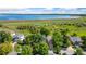 Aerial view of homes surrounded by lush green trees with a large lake in the distance at 6055 W Progress Ave, Littleton, CO 80123