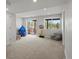 Bright basement area with walkout access, neutral carpet, and sliding glass doors to the backyard at 6055 W Progress Ave, Littleton, CO 80123