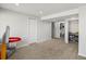 Finished basement area featuring neutral carpet, recessed lighting, access to bath, and ample space at 6055 W Progress Ave, Littleton, CO 80123