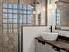 A stylish bathroom showing a stand up shower, a vanity with a vessel sink, and a framed mirror at 6055 W Progress Ave, Littleton, CO 80123