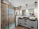 This bathroom features a stand up shower and a double sink vanity at 6055 W Progress Ave, Littleton, CO 80123