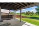 Covered patio overlooking backyard with open field and wooded area in the distance, offering peaceful outdoor living at 6055 W Progress Ave, Littleton, CO 80123