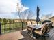 Outdoor deck with table and chairs, perfect for entertaining with scenic backyard views at 6055 W Progress Ave, Littleton, CO 80123