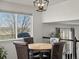Cozy dining area with a view and modern light fixture at 6055 W Progress Ave, Littleton, CO 80123
