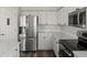Modern kitchen with stainless steel appliances, white cabinets, and sleek countertops at 6055 W Progress Ave, Littleton, CO 80123